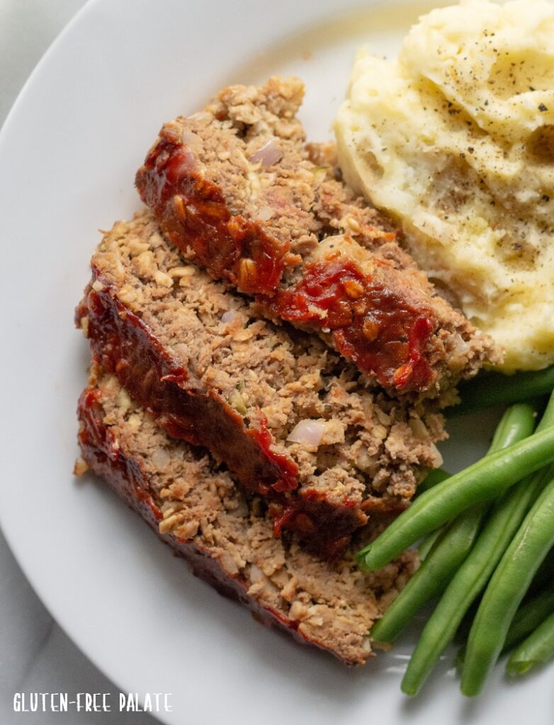 A close up of Gluten-Free Meatloaf slices on a white plate.