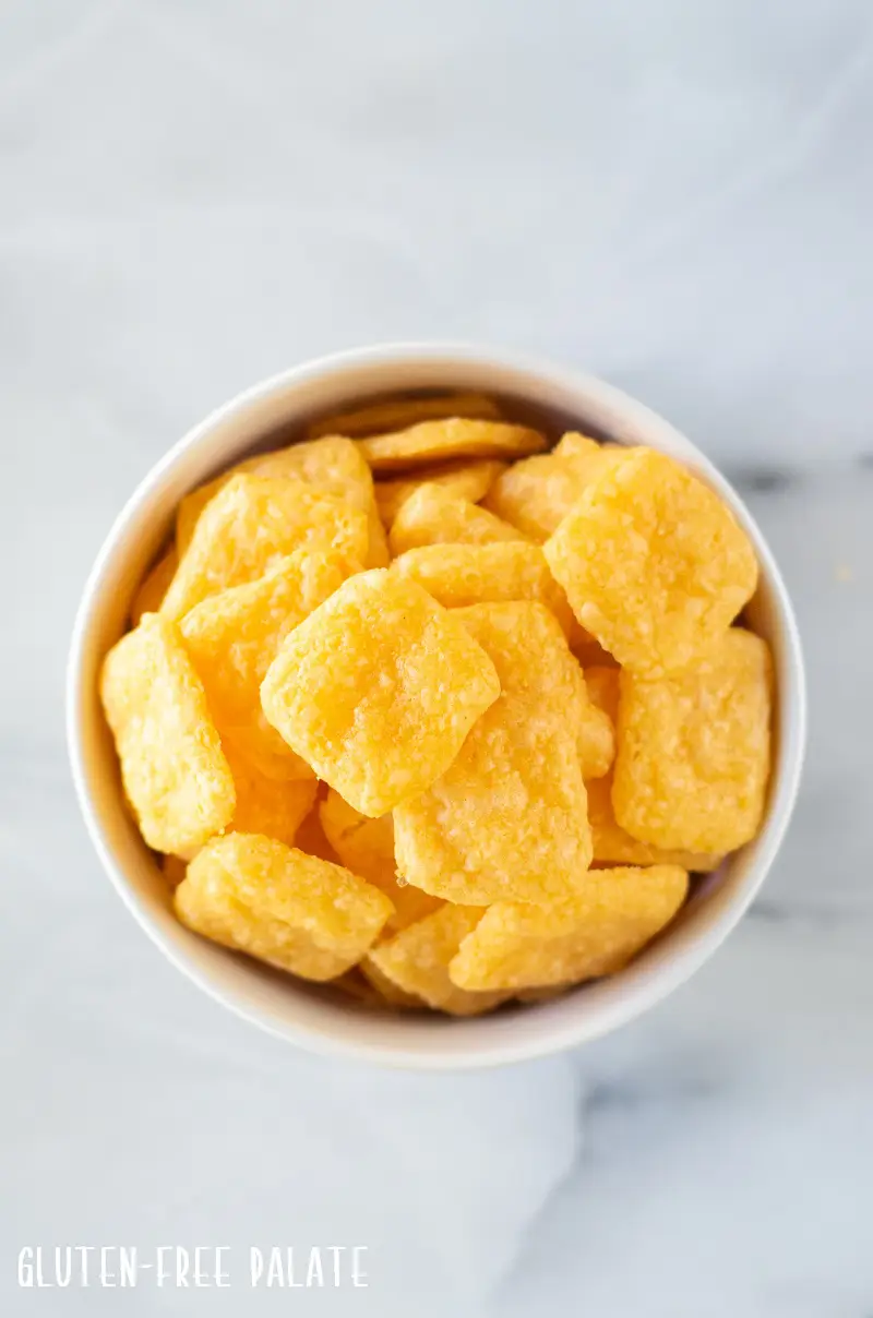top down view of gluten free cheese crackers in a white bowl