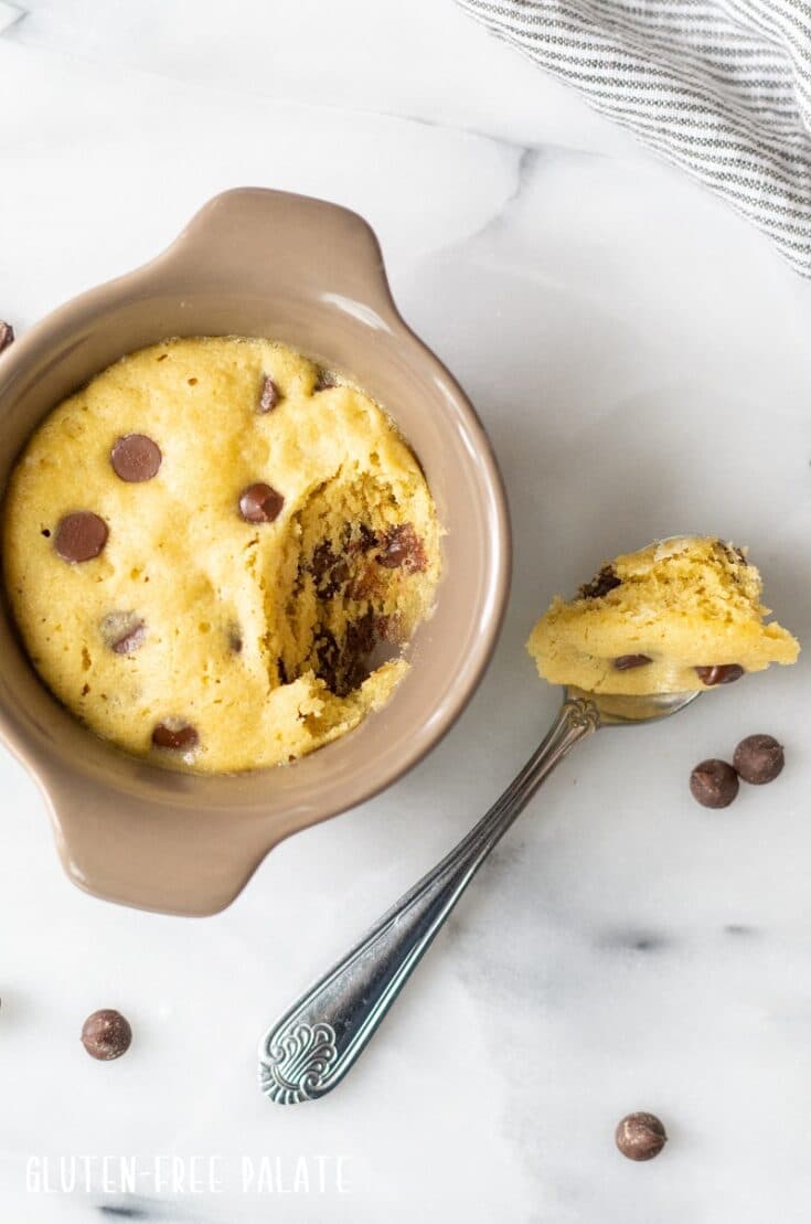 Gluten Free Chocolate Chip Mug Cookie with a spoon with cookie on it