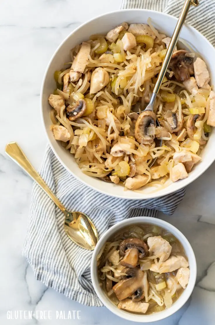 chicken subgum chow mein in a white bowl with a spoon next to a small bowl of subgum