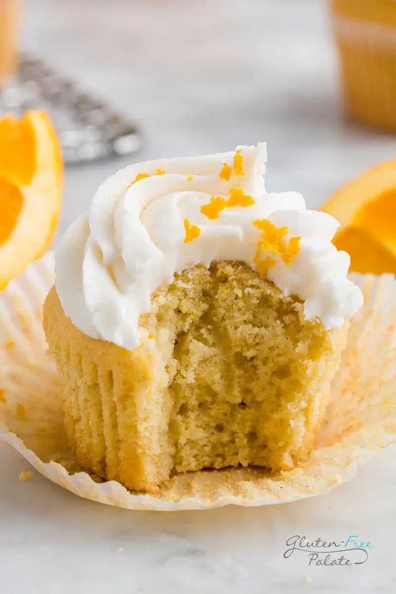 gluten free orange cupcake with a bite out of it