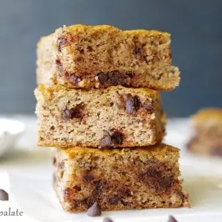 a close up of three paleo banana bars with chocolate chips stacked