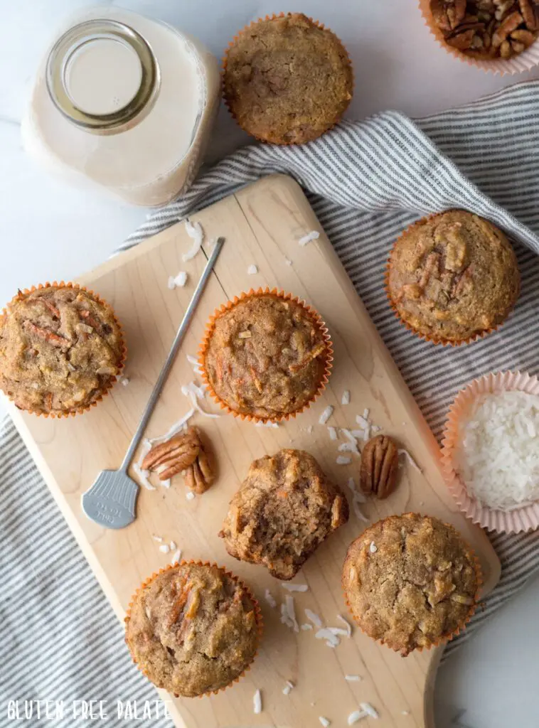 a top down view of paleo carrot muffins on a cutting board next to a jar of milk