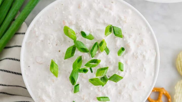 top down photo of seafood dip topped with sliced green onions
