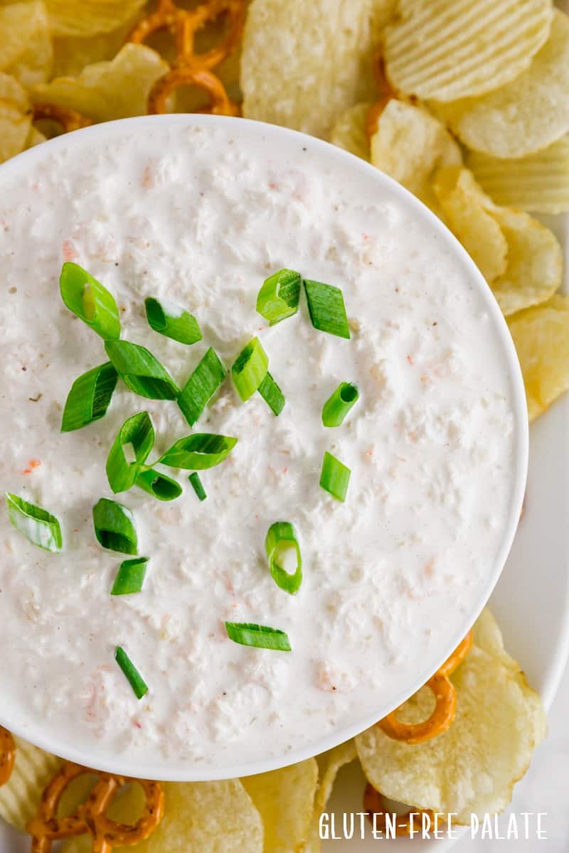 close up photos of seafood dip topped with sliced green onions