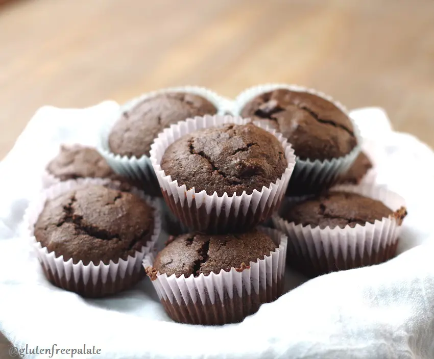 gluten free chocolate muffins arranged on a white towel