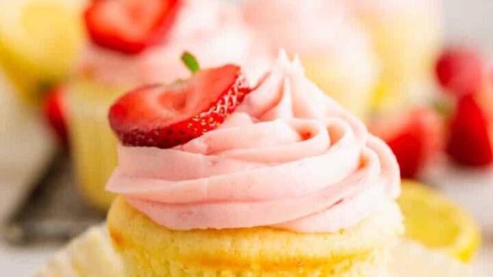 a gluten-free strawberry cupcakes with strawberry frosting with a strawberry half on top