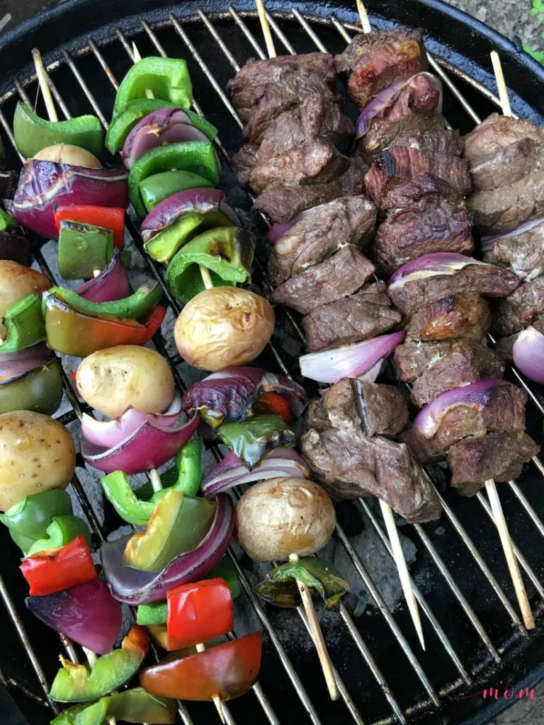 beef and vegetable kebabs on a grill