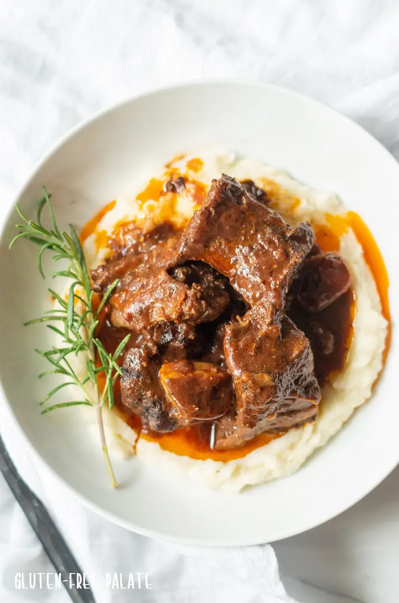top down view of beef short ribs over mashed potatoes
