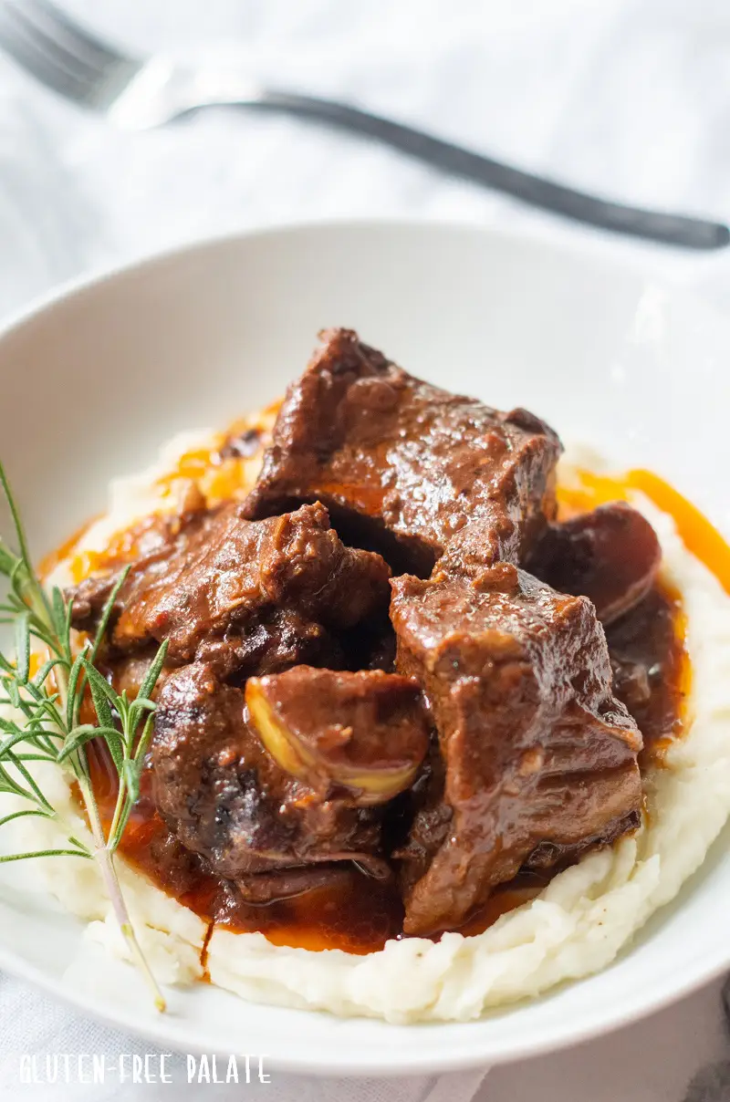 side view of beef short ribs over mashed potatoes