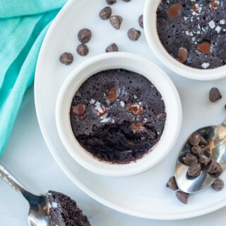 top down view of a vegan mug brownie in a ramekin with a bite out