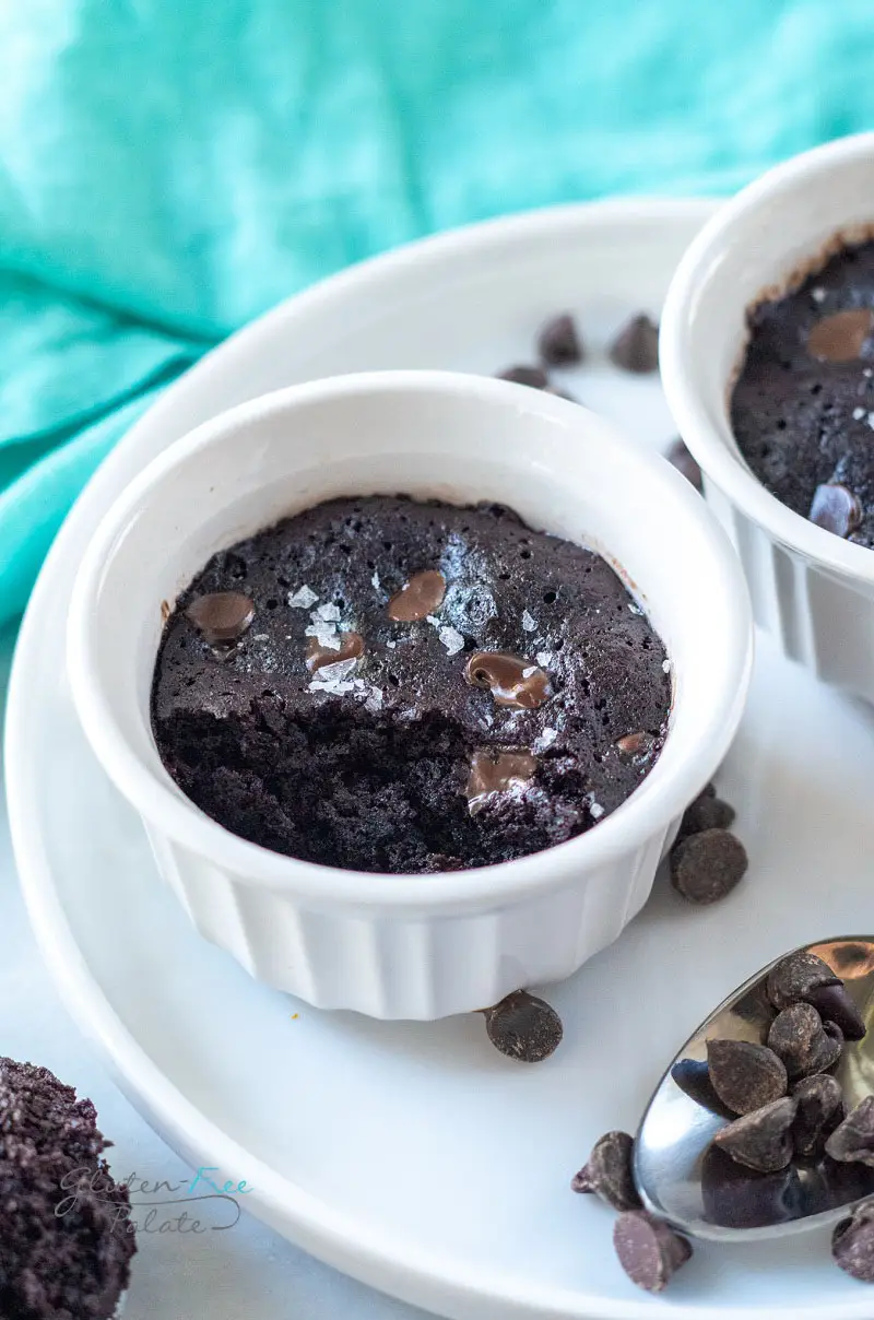 angled view of a vegan mug brownie in a ramekin with a bite out