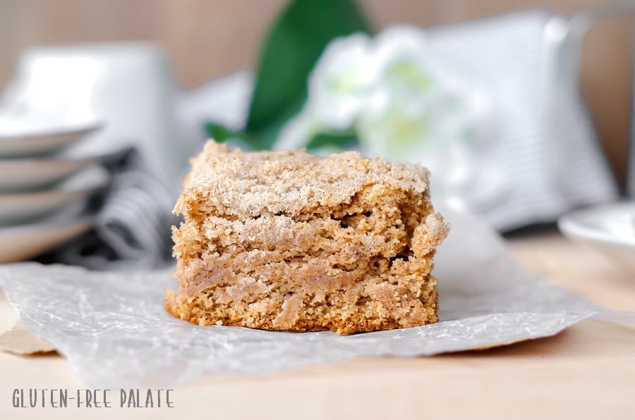 a slice of gluten free chai coffee cake on a piece of parchment paper