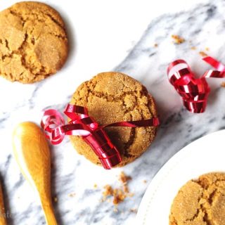 a close up of Gluten Free ginger snap cookies wrapped with a red ribbon for decaration