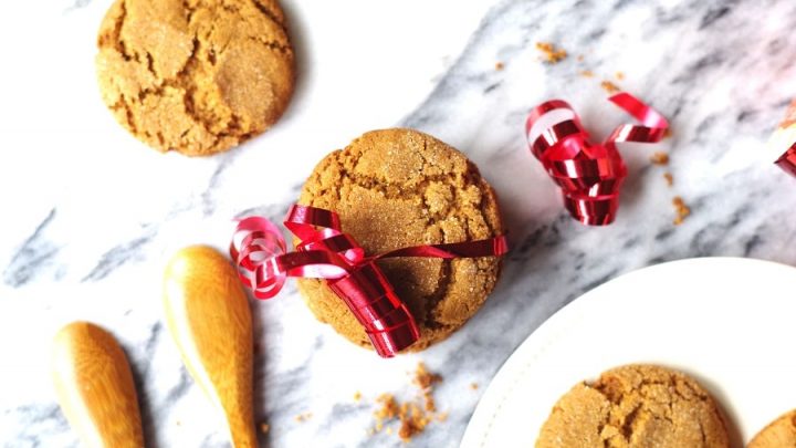 a close up of Gluten Free ginger snap cookies wrapped with a red ribbon for decaration