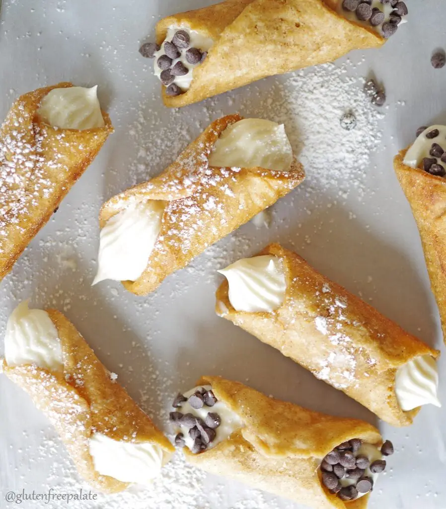 a top down view of cannolis dusted with powdered sugar