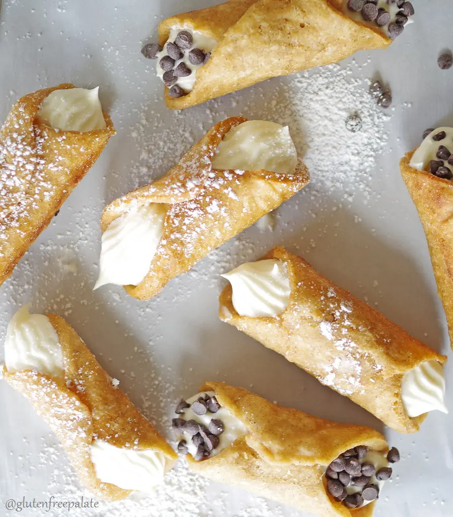 a close up of a top down view of cannolis dusted with powdered sugar