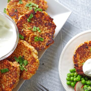 a close up of Gluten-Free Salmon Cakes on a white plate with green garnish next to a plate of salmon cakes and peas
