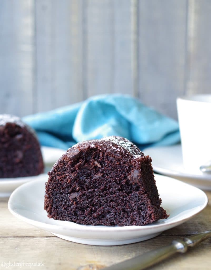 A slice of gluten-free chocolate bundt cake on a white plate