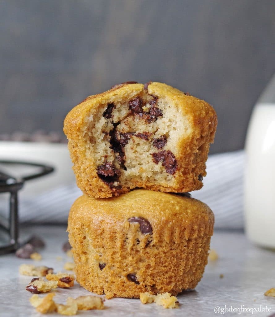 two paleo chocolate chip muffins stacked, the one on top has a bite out