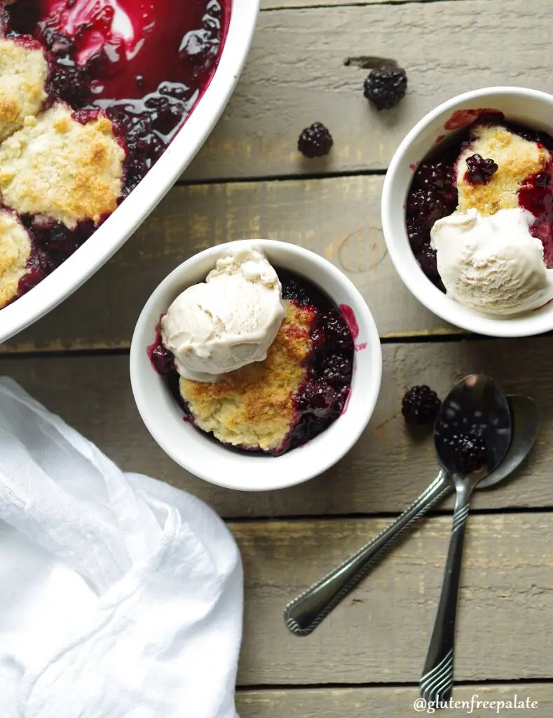 Gluten-Free Blackberry Cobbler in a white baking dish with vanilla ice cream
