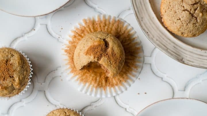 a close up of paleo snickerdoodle muffins on a white counter