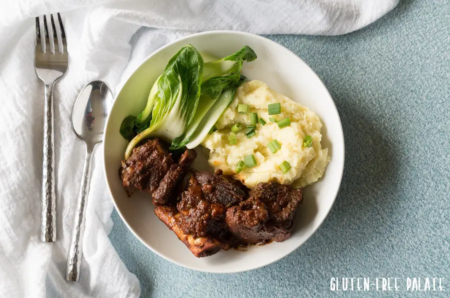 a top down view of instant pot short ribs, mashed potatoes and green vegerables
