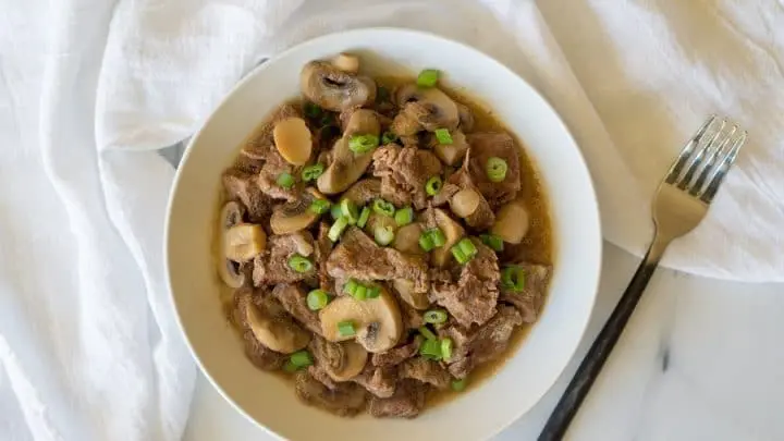 Top view Paleo Beef Sirloin Tips on a white plate with a fork