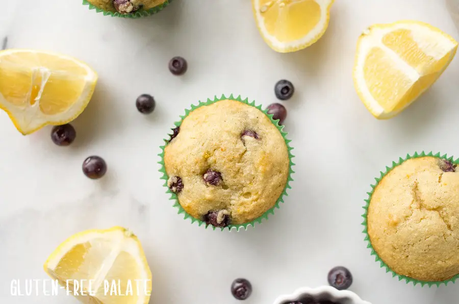 top down view of paleo blueberry muffins next to lemon wedges