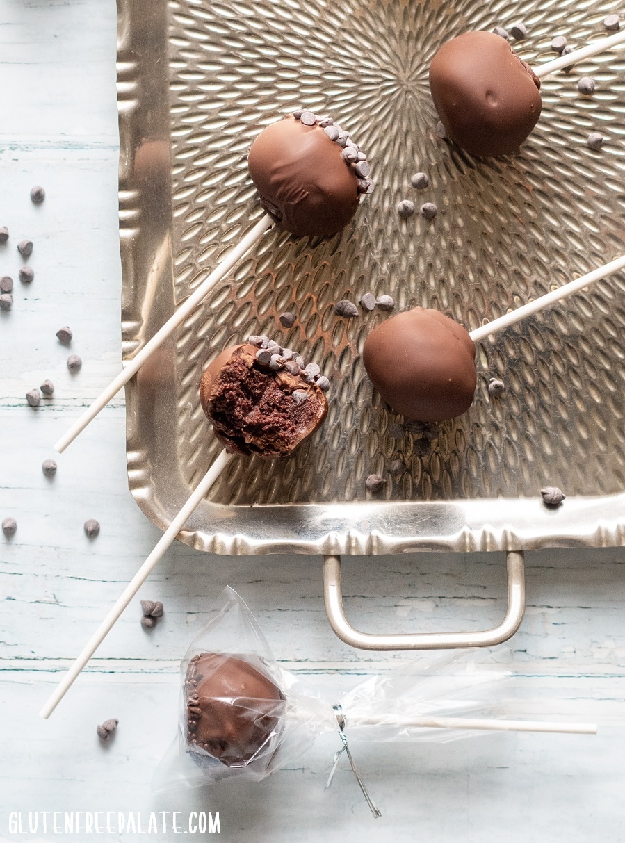 Gluten-Free Cake Pops covered in chocolate on a stick, on a metal tray