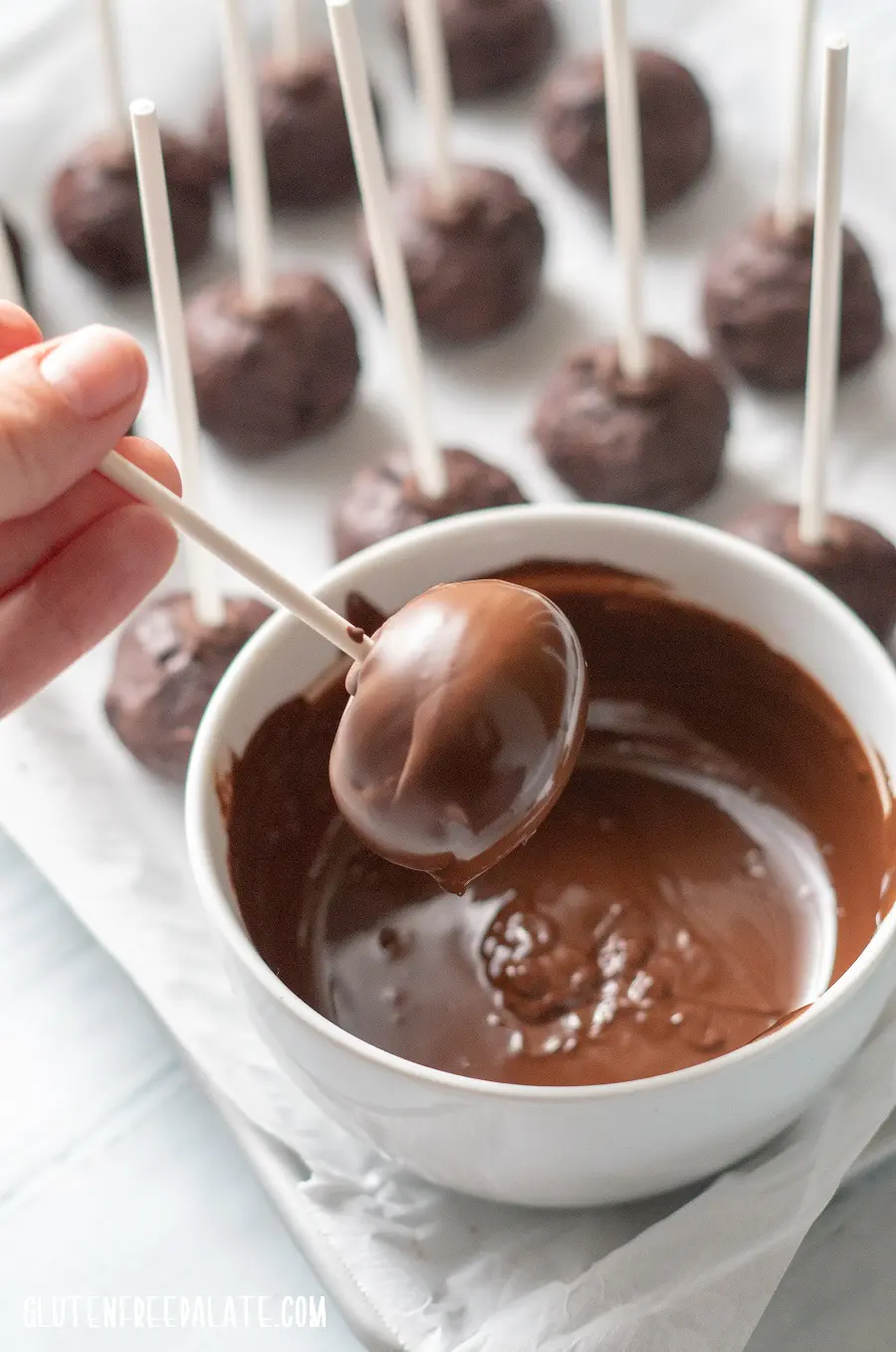 Gluten-Free Cake Pops covered in chocolate on a stick