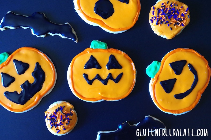 gluten-free sugar cookie pumpkins and bats decorated for Halloween