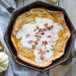 a close up of Gluten free pumpkin spice dutch baby in a cast iron skillet