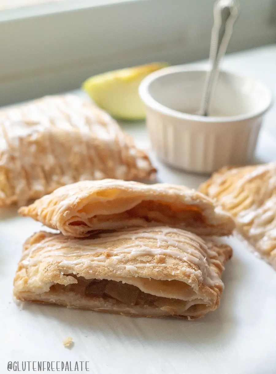 a side view of an apple turnover cut in half to show the apple filling