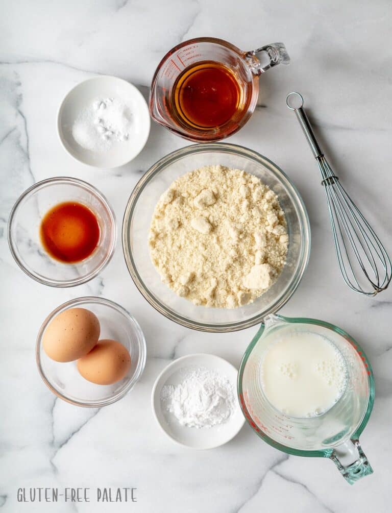 Paleo Pancake Mix ingridients in glass bowls next to a whisk