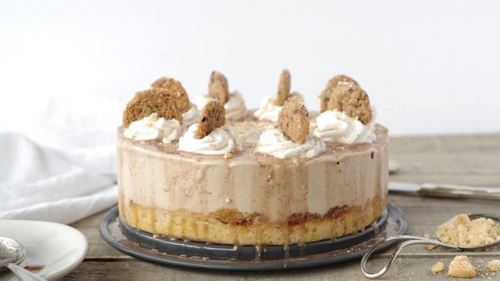 cinnamon roll ice cream cake topped with whipped cream and cookies