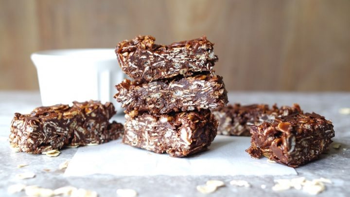 side view of three stacked gluten free chocolate coconut oat squares