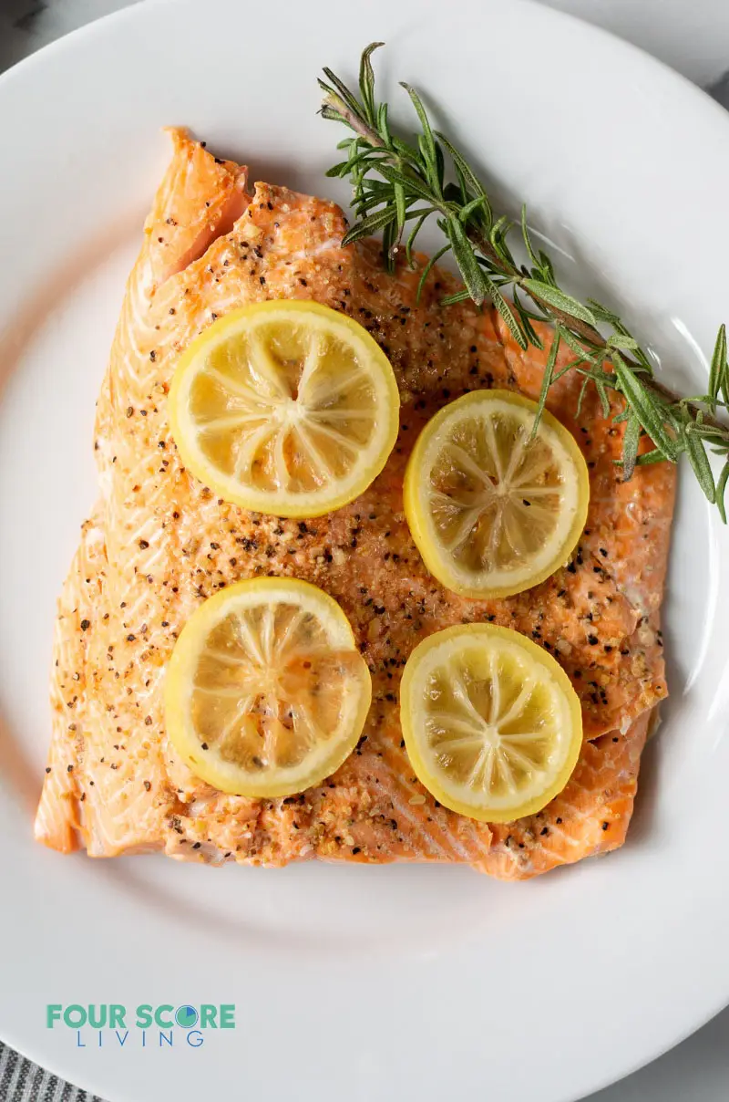 salmon topped with lemon slices on a white plate - gluten-free instant pot recipes
