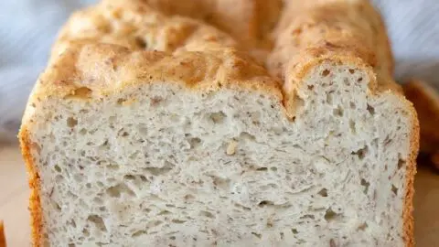 a close up of the inside of a loaf of gluten free bread on a cutting board