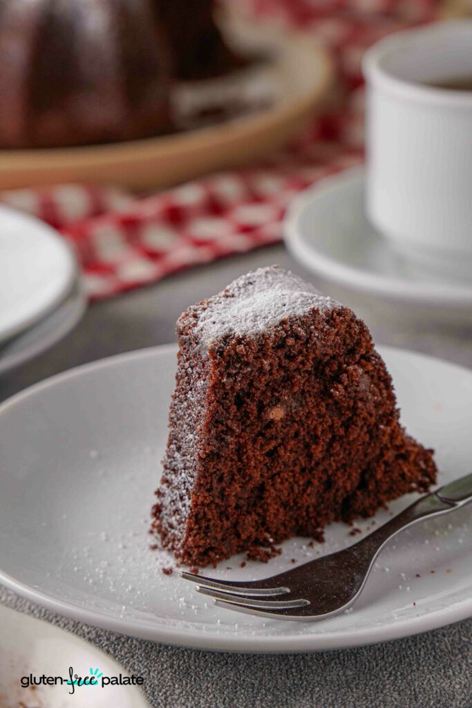 A slice of Gluten-free chocolate bundt cake on a white plate.