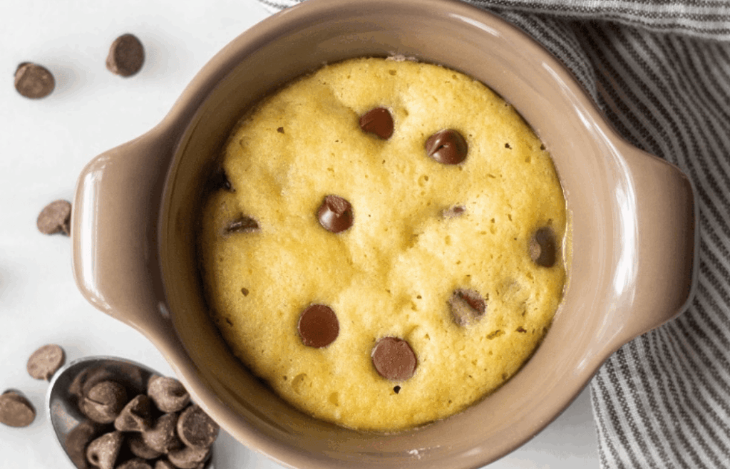 A gluten-free chocolate chip mug cookie, still in the mug.