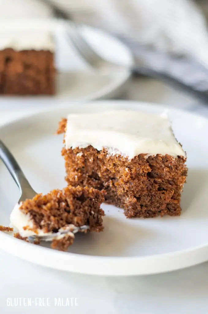 a slice of Gluten Free Gingerbread Cake on a white plate with a fork