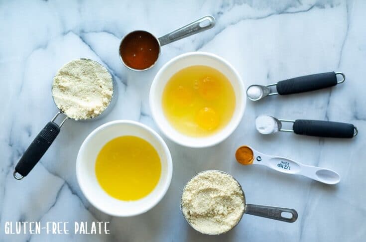 ingredients in paleo cornbread, almond flour, maple syrup, eggs, melted butter, turmeric, salt, baking powder