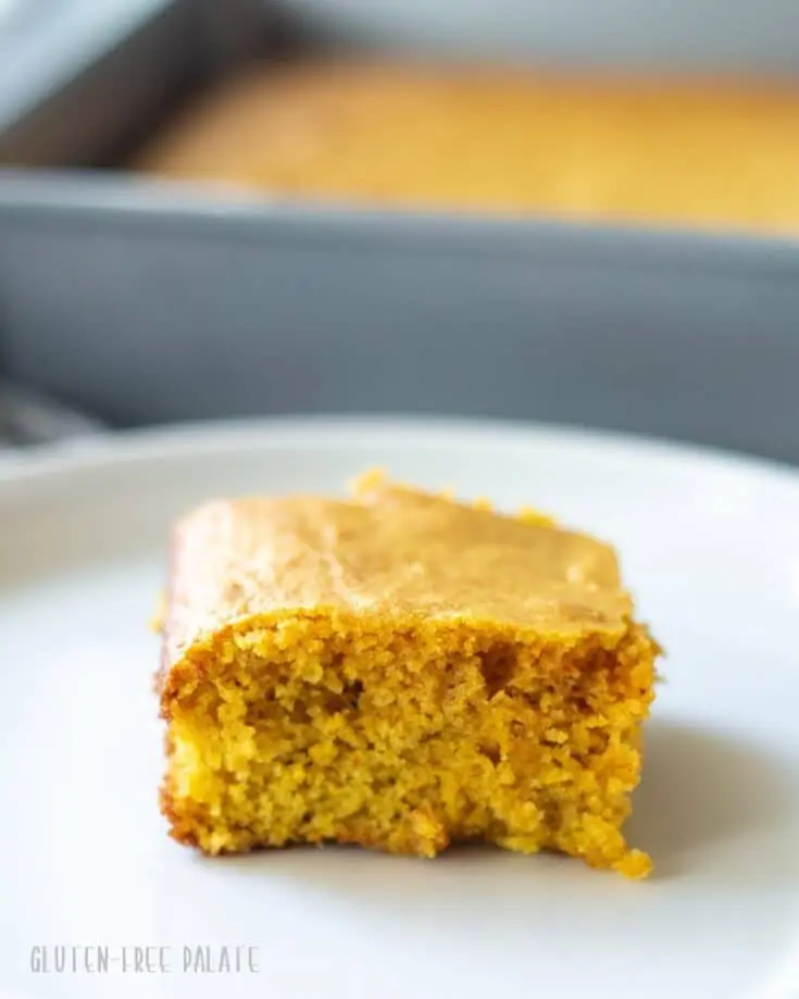 a slice of yellow paleo cornbread on a white plate