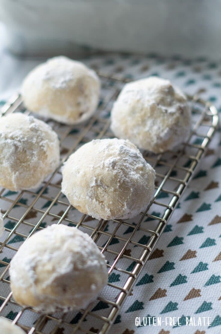 gluten free snow ball cookies on a cookie rack