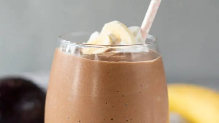Chocolate Avocado Smoothie in a glass with a pink straw