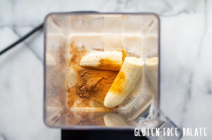 banana, milk, ice and turmeric in a blender jar