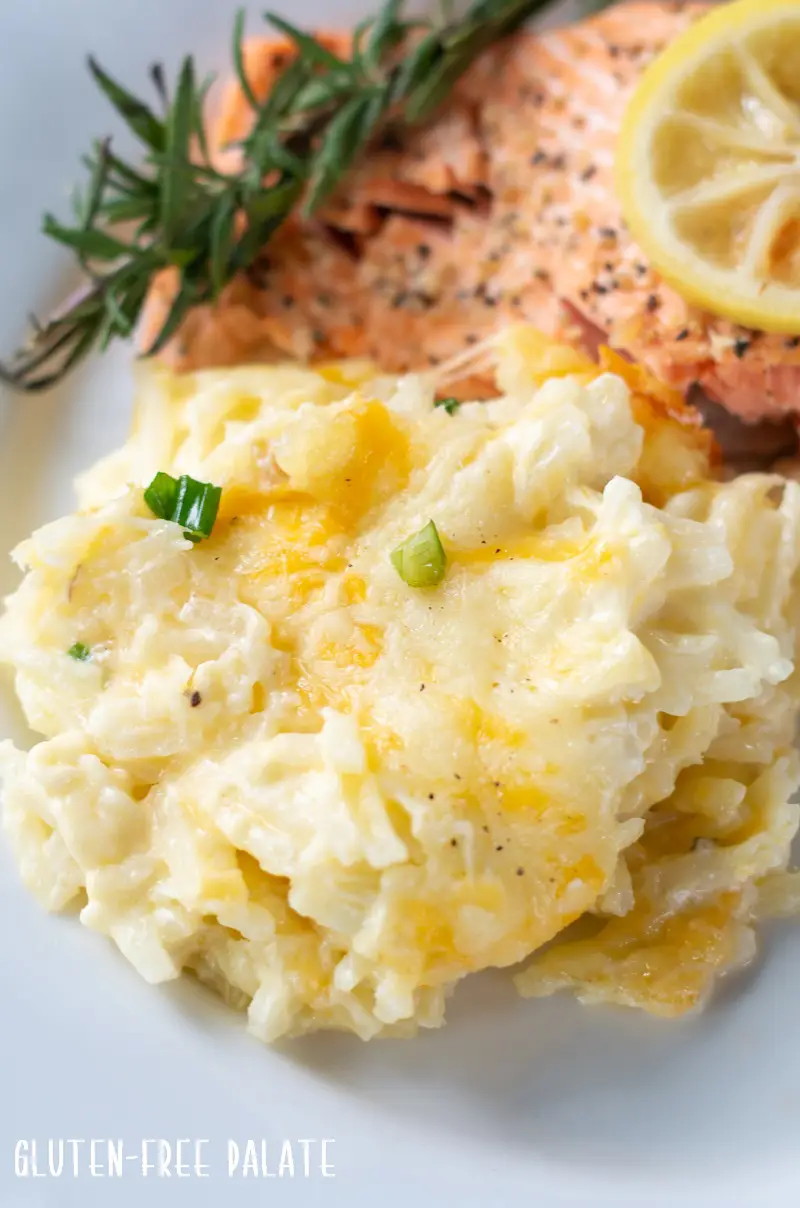 Cheesy Potatoes on a plate with salmon