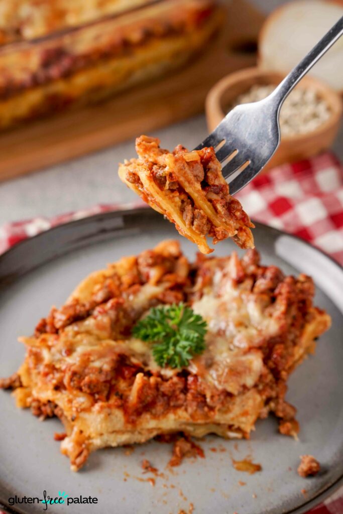 Gluten-Free lasanga on a plate with a fork holding a bite.