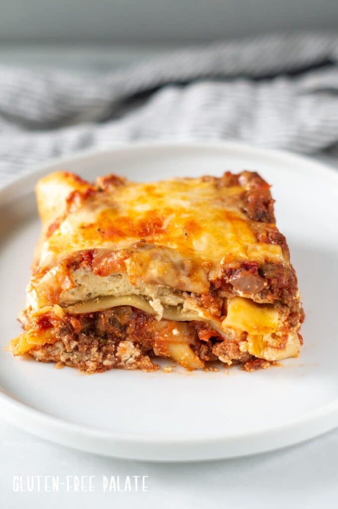 A serving of gluten free lasagna on a white plate